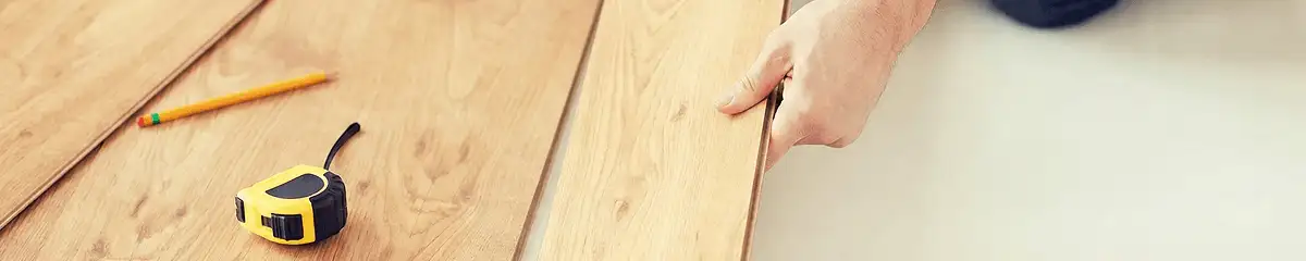 A professional installing wood flooring in Milwaukee, WI