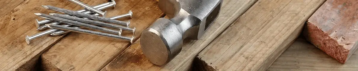 Hammer and nails on hardwood flooring boards in Milwaukee, WI