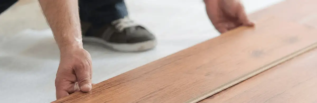 A professional installing laminate flooring in Milwaukee, WI